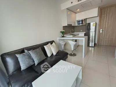 Modern open-layout living room with sleek kitchen and stylish furnishings