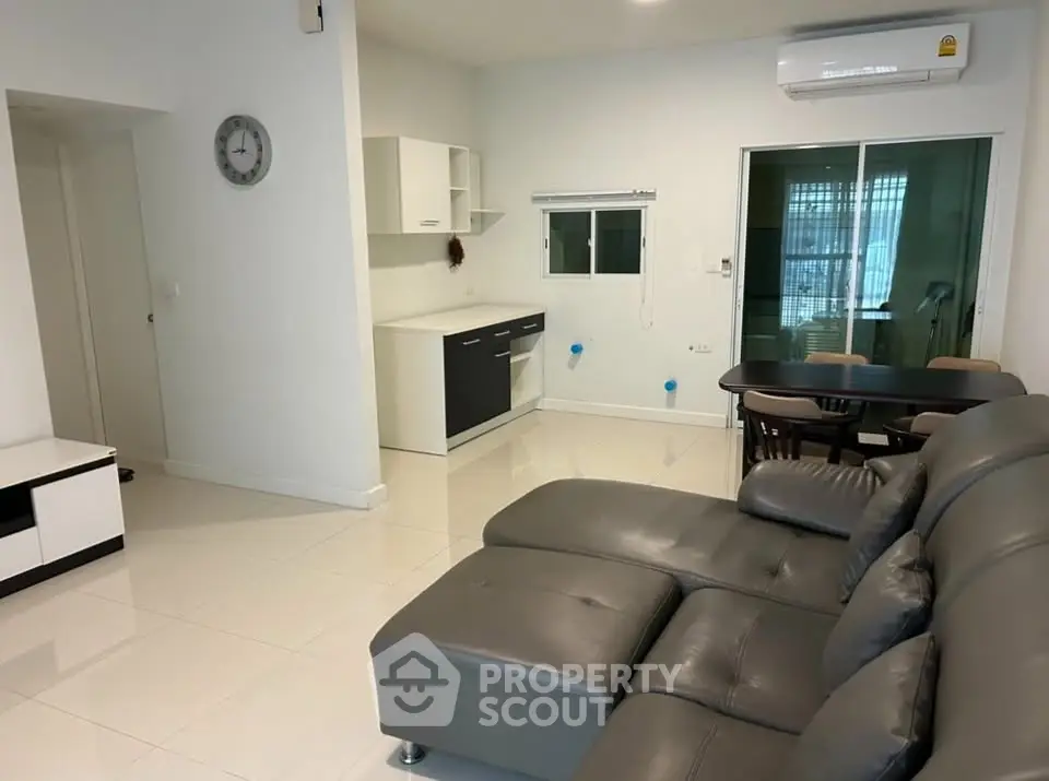 Modern living room with sleek furniture and open kitchen layout