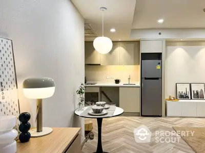 Modern kitchen with sleek design and open layout, featuring stylish lighting and contemporary decor.