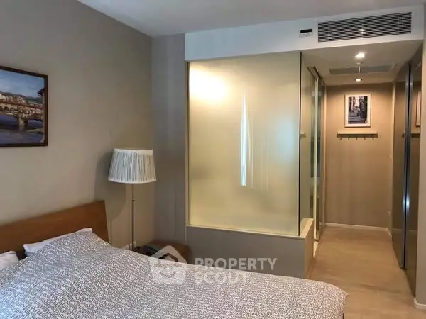 Modern bedroom with frosted glass partition and stylish decor