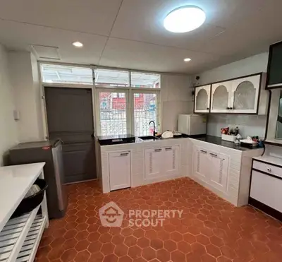 Spacious kitchen with terracotta tiles and ample natural light