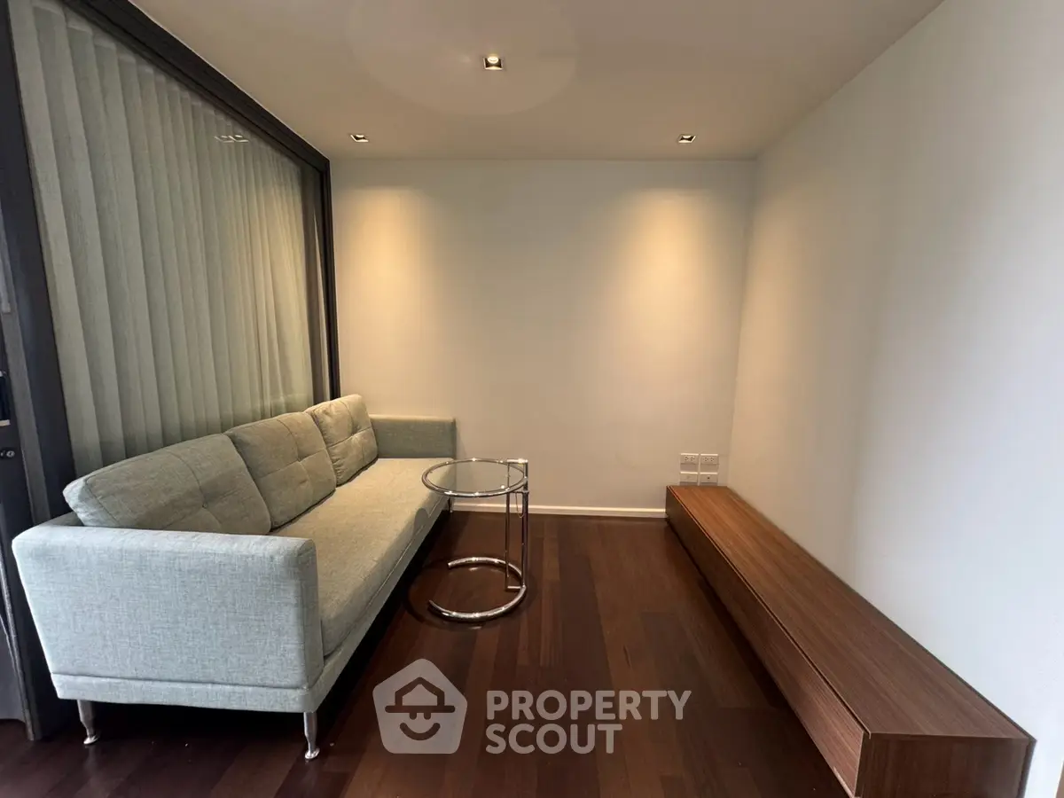 Modern minimalist living room with sleek sofa and wooden flooring