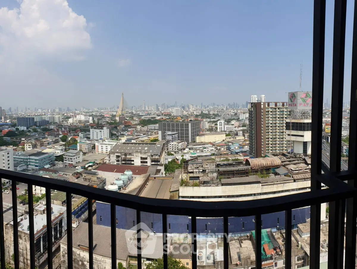 Stunning cityscape view from high-rise balcony overlooking urban skyline.