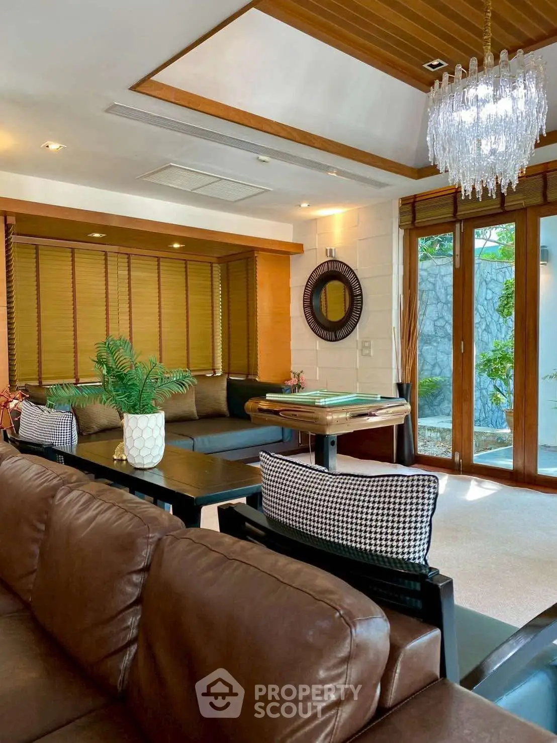 Luxurious living room with elegant chandelier and cozy seating area, perfect for relaxation and entertainment.