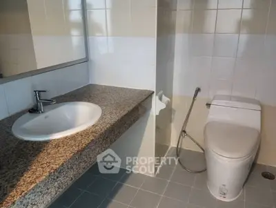 Modern bathroom with sleek fixtures and granite countertop