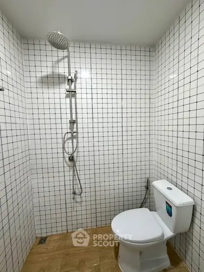 Modern bathroom with white tiled walls and wooden floor
