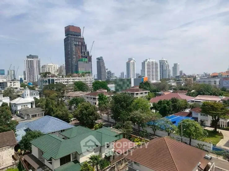 Stunning cityscape view showcasing modern high-rise buildings and lush residential area.