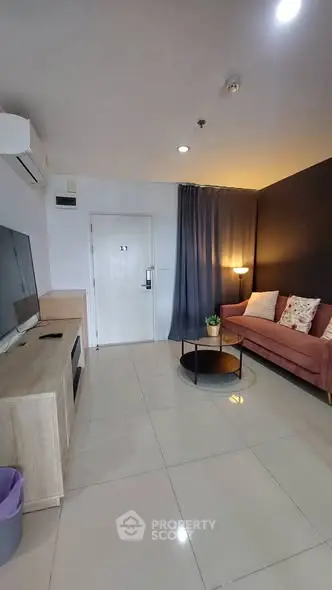 Modern living room with sleek design, featuring a cozy sofa, stylish coffee table, and wall-mounted TV.