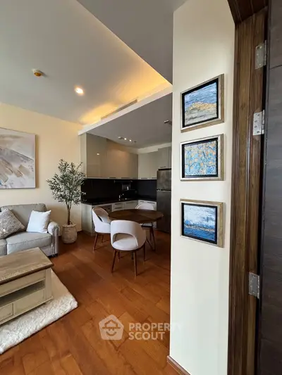 Stylish open-plan living room and kitchen with modern decor and wooden flooring.
