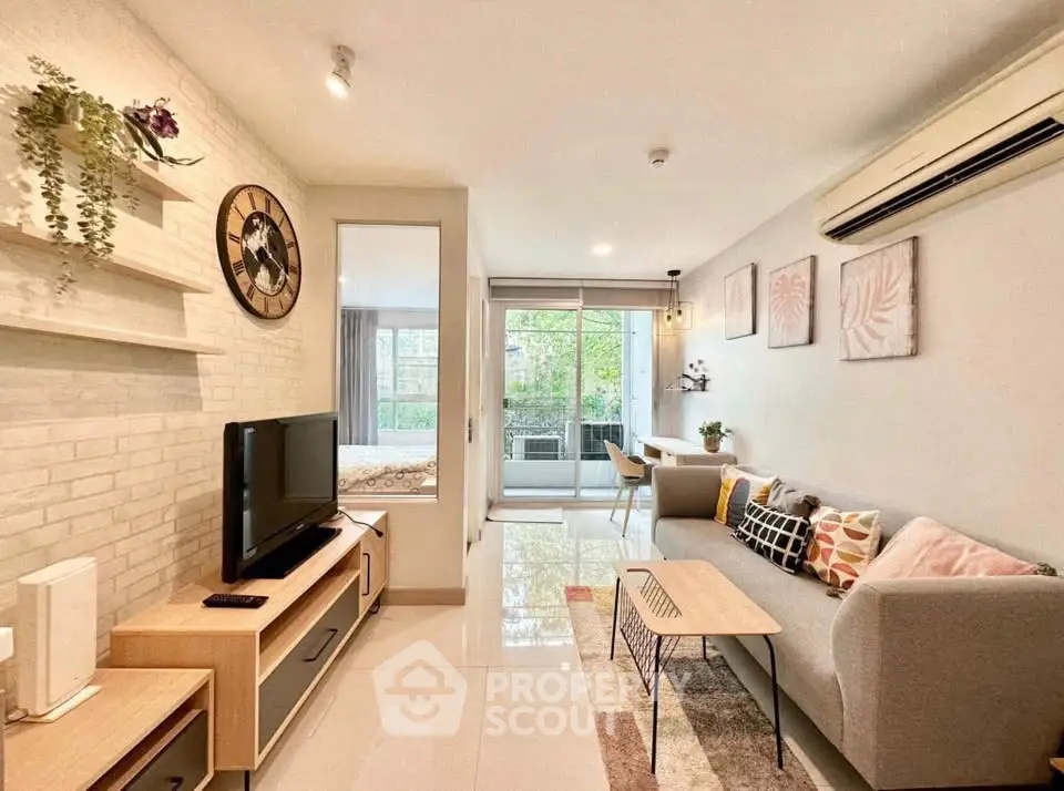 Modern living room with stylish decor and open layout leading to a bright balcony view.