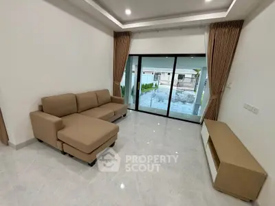 Modern living room with sliding glass doors and stylish furniture