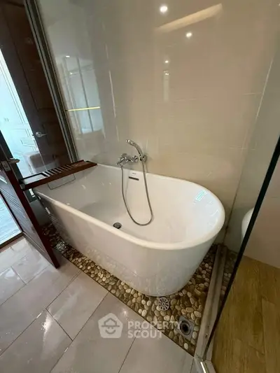 Luxurious bathroom with elegant freestanding bathtub and modern fixtures.