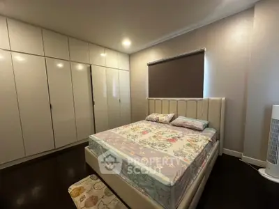 Spacious bedroom with modern wardrobe and cozy bed in elegant apartment