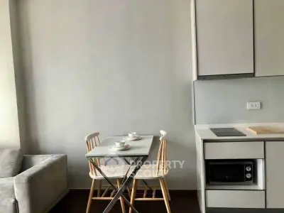 Modern compact kitchen with dining area and sleek cabinetry