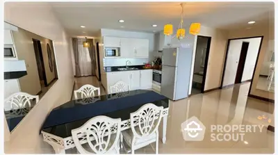 Spacious dining area with elegant decor and modern kitchen in open layout apartment