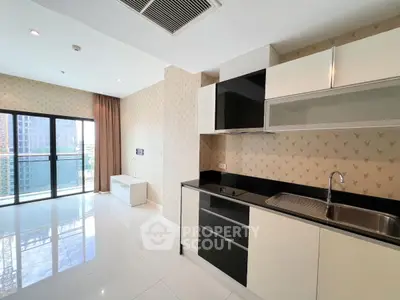 Modern kitchen with sleek cabinets and open layout in bright apartment