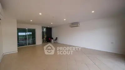 Spacious empty living room with tiled flooring and air conditioning