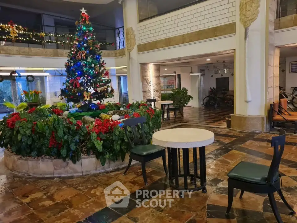 Festive building entrance with Christmas tree and seating area