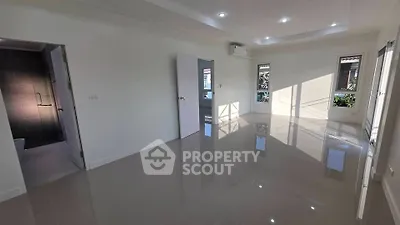 Spacious modern living room with glossy tiled floors and natural light