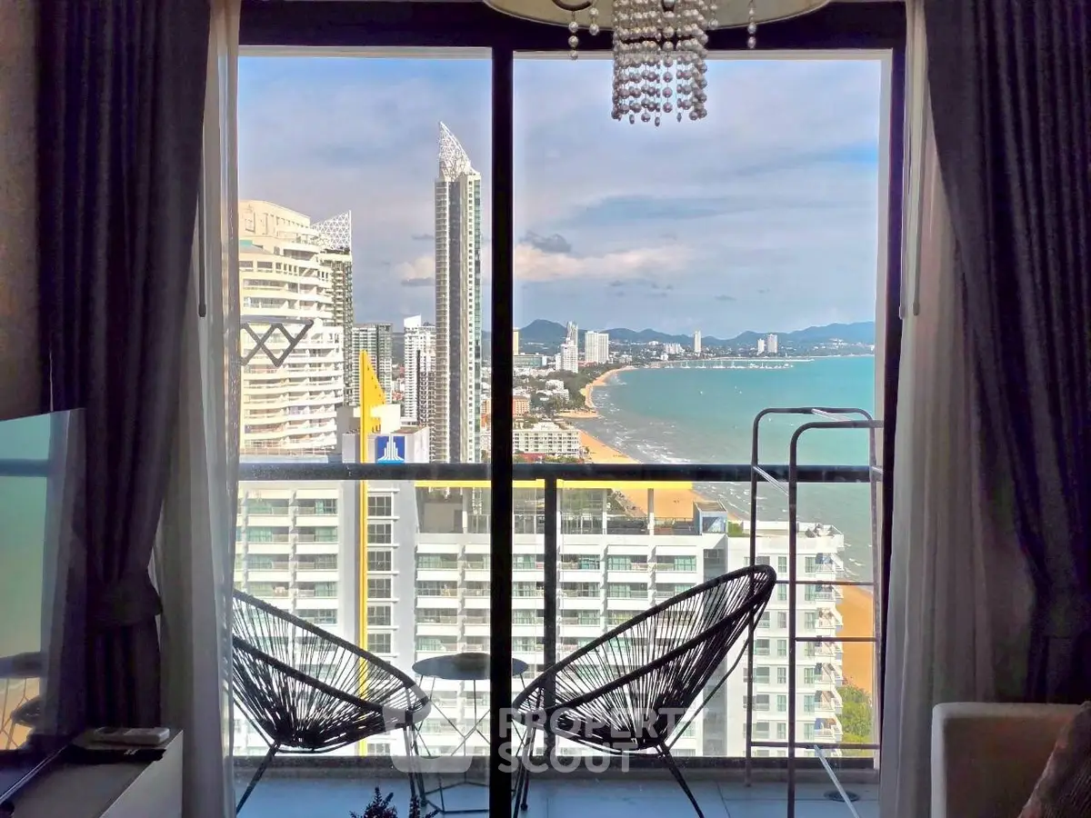 Stunning beachfront condo with panoramic ocean views and modern balcony seating.