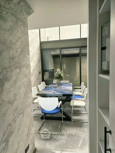 Elegant dining area with modern decor and natural light, featuring a stylish table and chairs in a contemporary setting.
