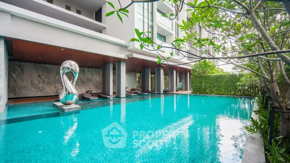 Luxurious residential pool area with modern design and lush greenery