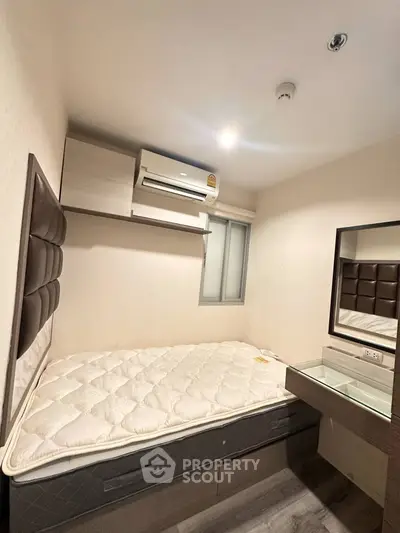 Cozy bedroom with modern furnishings and air conditioning unit