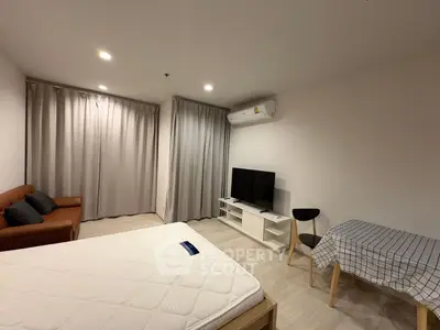 Modern studio apartment with cozy living area and stylish furnishings
