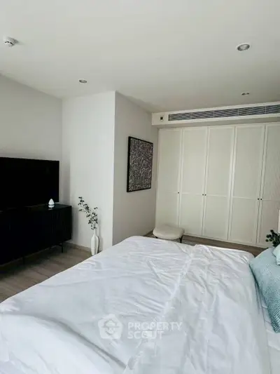 Modern bedroom with sleek design and ample storage space