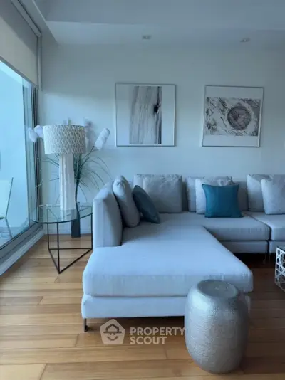 Modern living room with stylish decor and large windows