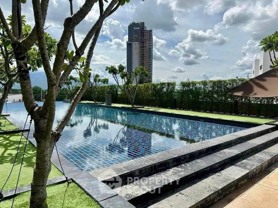 Luxurious rooftop pool with stunning city view and lush greenery