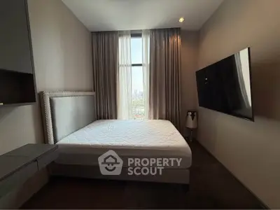 Modern bedroom with large window and wall-mounted TV, offering a city view.