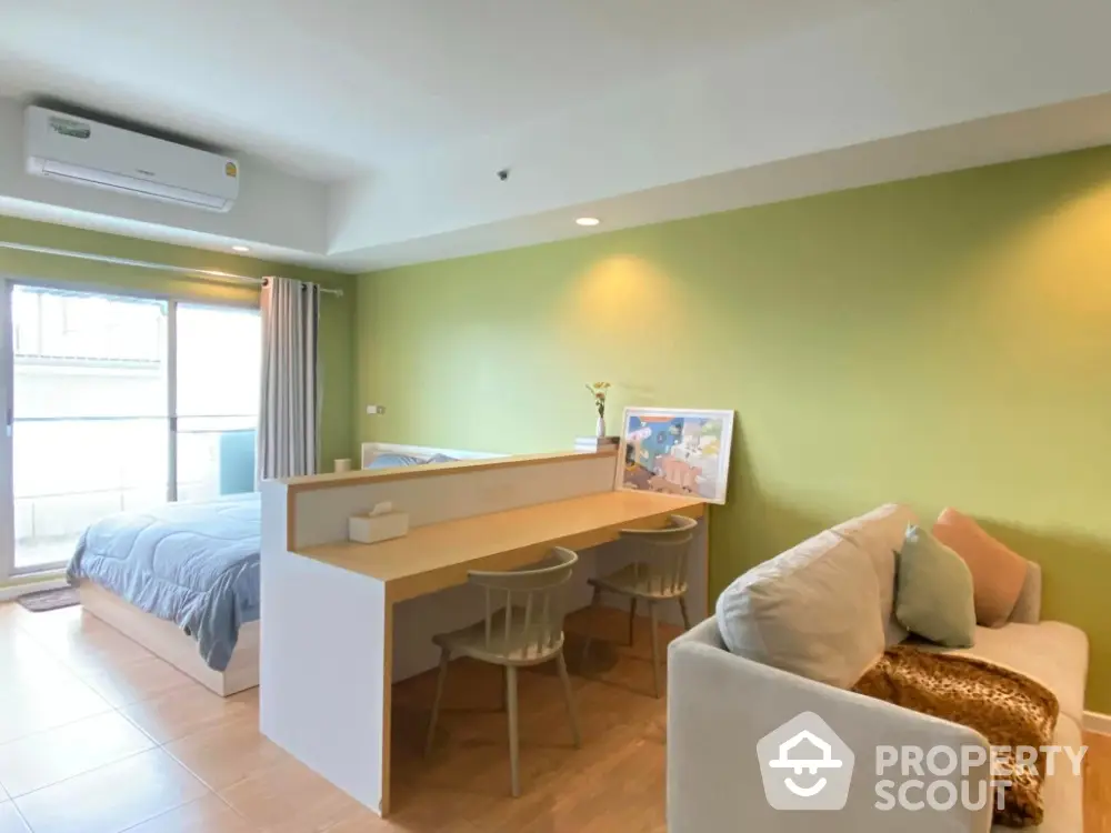 Modern studio apartment with stylish decor and open layout, featuring a cozy living area and comfortable bed.