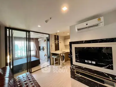 Modern open-plan living room with stylish decor and adjacent bedroom in a contemporary apartment.