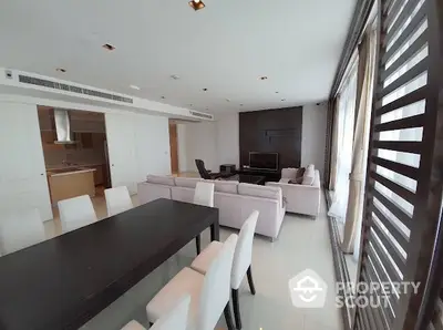 Spacious modern living room with dining area and open kitchen in luxury apartment