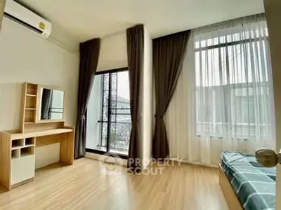 Spacious bedroom with large windows and modern decor