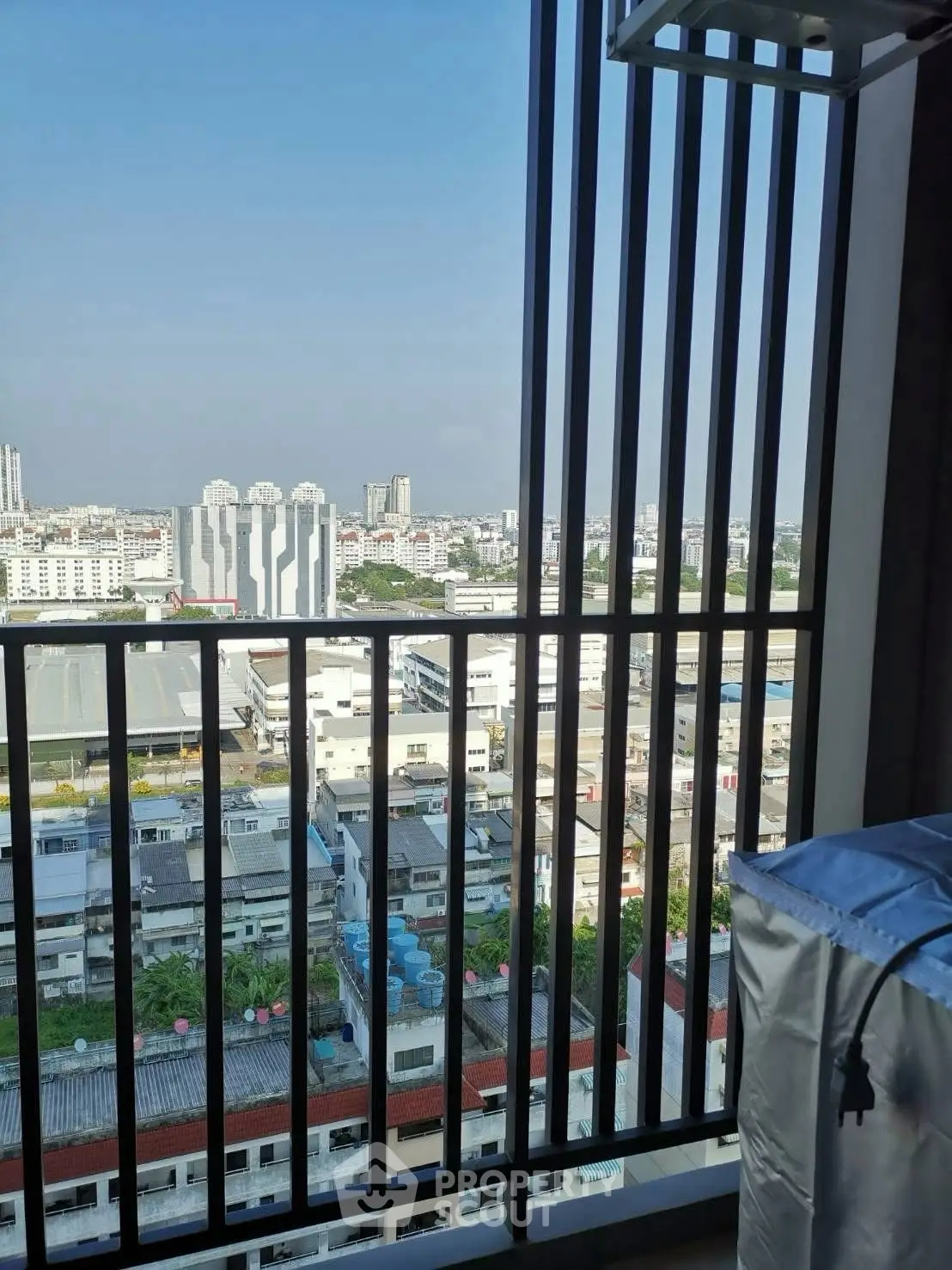 Stunning cityscape view from a high-rise balcony with modern railing design.