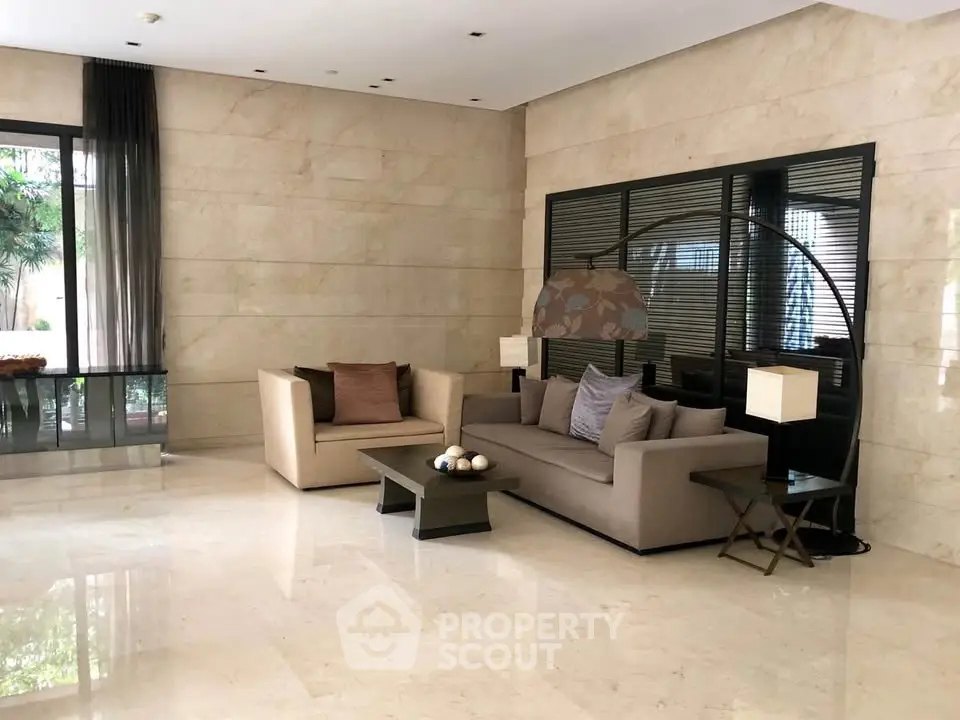 Elegant lobby with modern seating and marble flooring in luxury building.