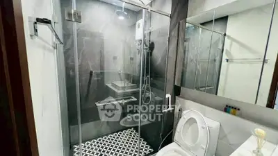 Modern bathroom with glass shower and stylish black and white tiles