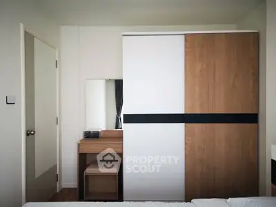 Modern bedroom with sleek wardrobe and vanity set, perfect for stylish living.