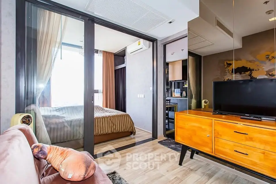 Modern apartment interior with cozy living room and bedroom, featuring stylish furniture and natural light.