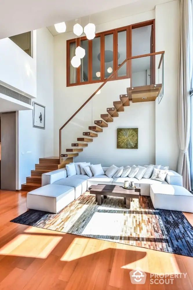 Luxurious modern living room with high ceilings and stylish staircase