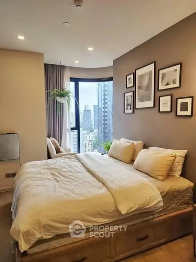 Modern bedroom with city view, featuring cozy bed and stylish decor in a high-rise apartment.
