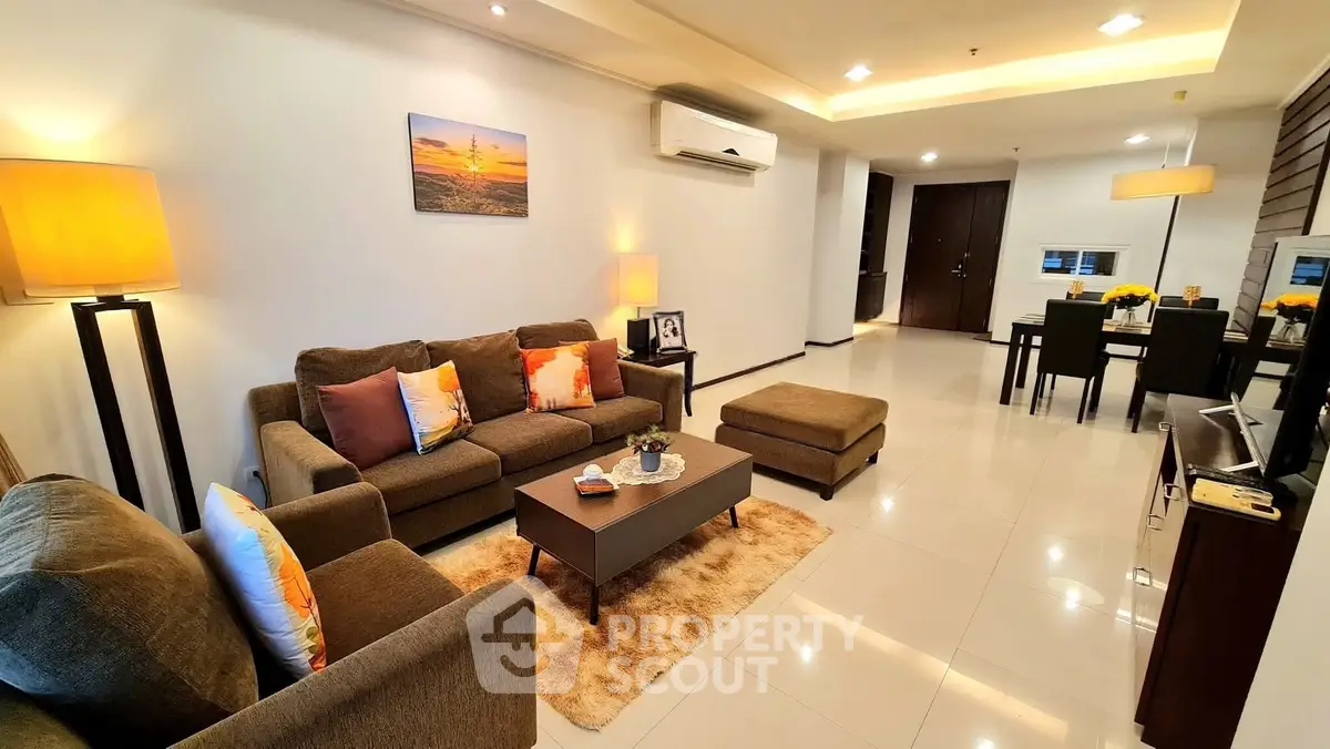 Spacious modern living room with elegant decor and cozy lighting in a luxurious apartment.