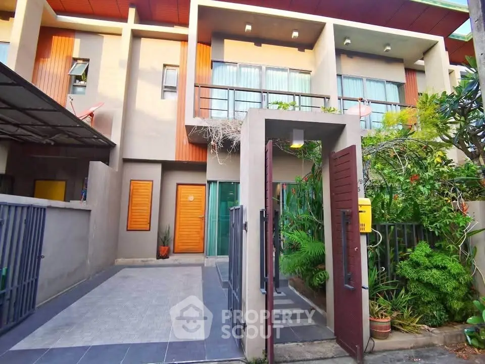 Modern townhouse with gated entrance and lush garden, perfect for urban living.
