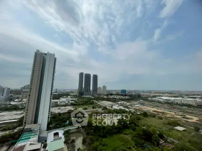 Stunning cityscape view from high-rise building showcasing urban skyline and lush greenery.