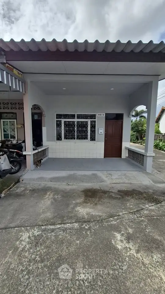 Charming single-story home with covered porch and modern facade in a serene neighborhood.