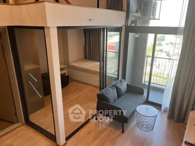 Modern studio apartment with glass-walled bedroom and balcony view