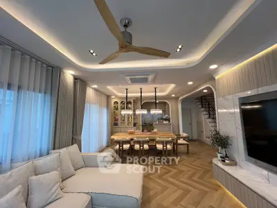 Luxurious open-plan living room with elegant decor and modern lighting