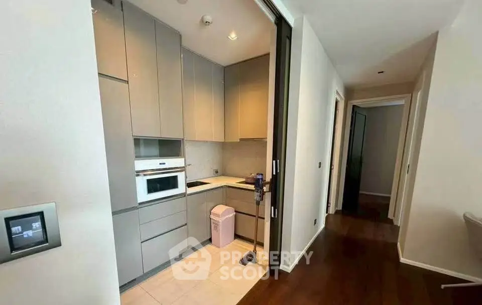 Modern compact kitchen with sleek cabinetry and built-in appliances